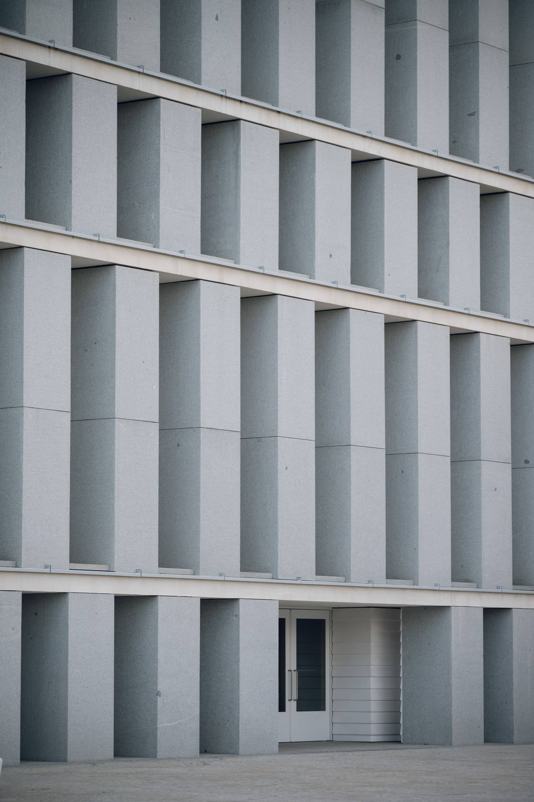 Düşey beton kanatların oluşturduğu ritmik modern yapı cephesi